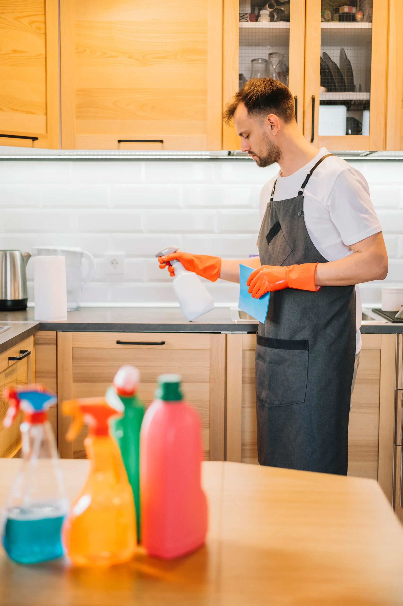 Eco-friendly cleaning products being used in a modern vacation rental kitchen