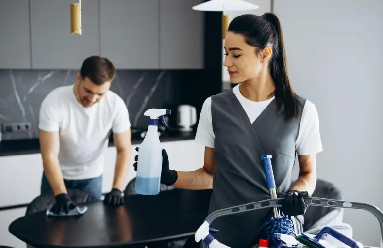 Professional-Vacation-Rental-Cleaning Professional cleaner sanitizing luxury vacation rental kitchen