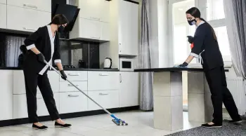 Professional housekeeper cleaning a luxury vacation rental kitchen