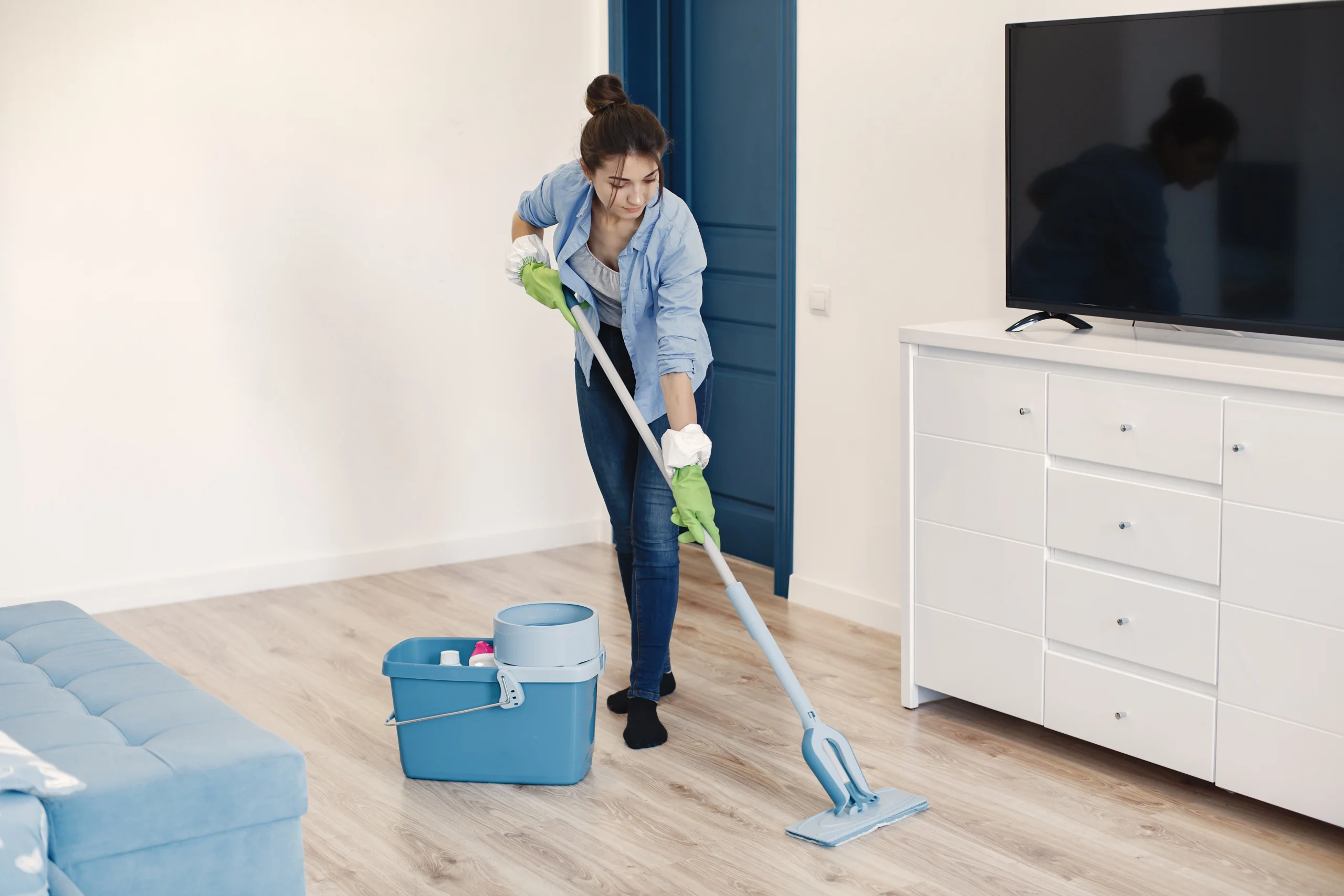 How many hours does it take to clean a room. A woman cleaning the floor, focused on maintaining a tidy and organized space.