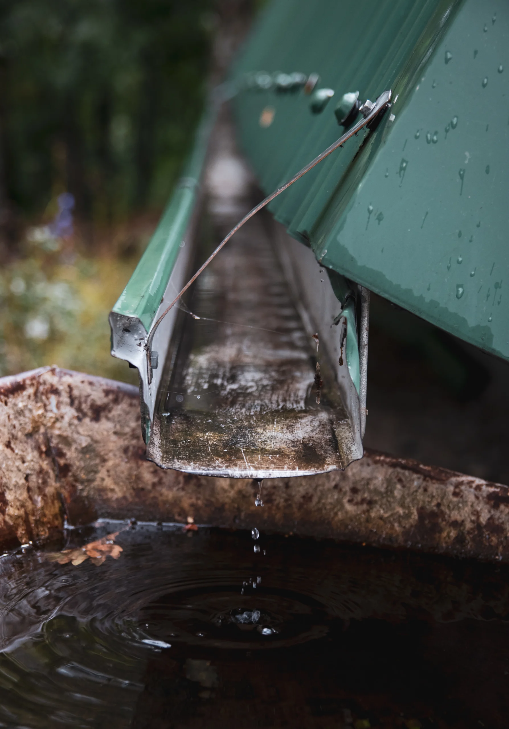 Clean gutters directing rainwater away from house foundation preventing flood damage