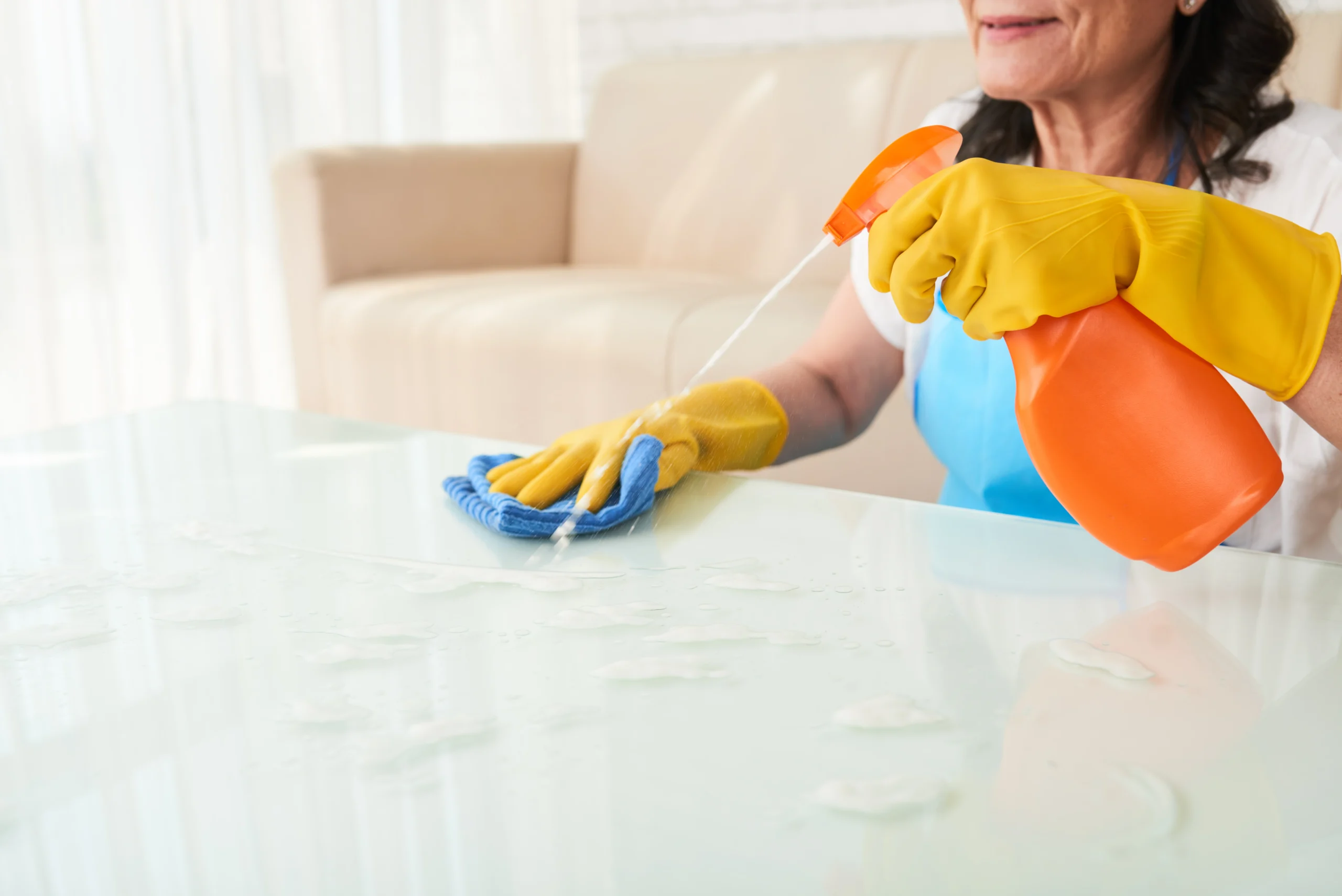 Professional cleaner scrubbing a modern living room as part of deep house cleaning services