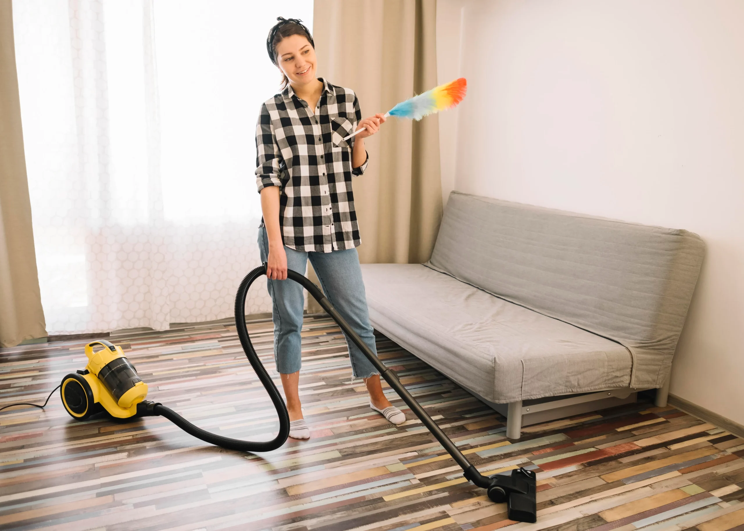 Professional cleaning team performing weekly house cleaning in a modern living room