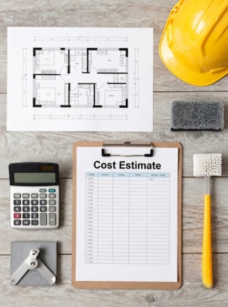 Contractor clipboard showing cost estimate alongside a blueprint and yellow hard hat
