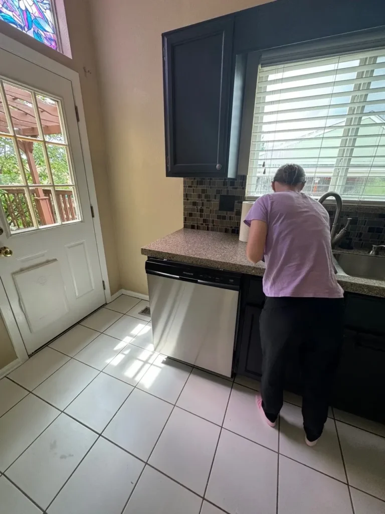 Professional House cleaning services in Castle Pines disinfecting and tidying a living room with eco-friendly products. Image description: A professional home cle